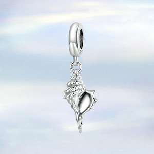 May include: A silver-colored charm featuring a detailed seashell design. The charm has a loop at the top for attaching to a bracelet or necklace. The seashell has a spiral shape and a pointed end, with a smooth, reflective surface.