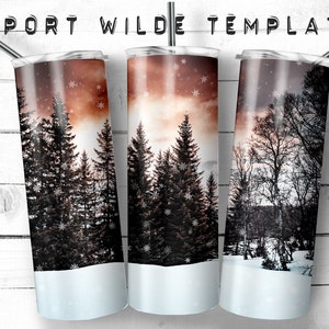 May include: Three stainless steel tumblers with a winter forest scene. The design features tall evergreen trees and falling snowflakes against a sunset sky. The text "PORT WILDE TEMPLATE" is at the top.