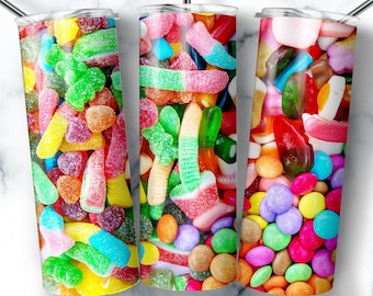 May include: Three stainless steel tumblers with colorful candy designs. The tumblers are filled with gummy candies, jelly beans, and chocolate candies.