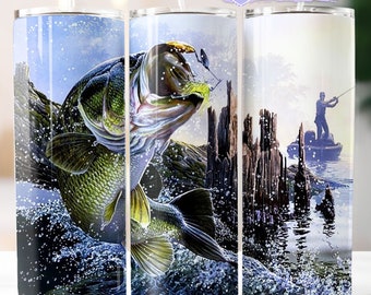 May include: A stainless steel tumbler featuring a vibrant fishing scene. The design showcases a large fish leaping out of the water, with a fisherman in the background. The tumbler includes the text "15 Free tumblers designs included".