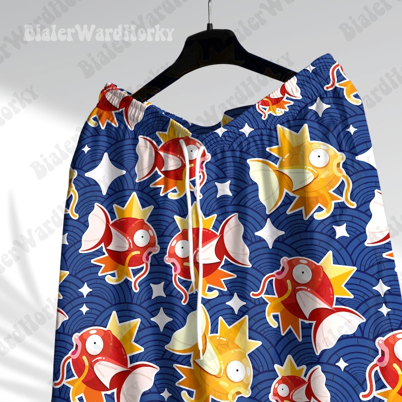 May include: Blue and orange patterned swim trunks with a repeating design of a cartoon fish with a star-shaped fin. The fish is swimming in a blue and white wave pattern.