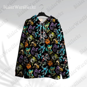 May include: Black hoodie featuring a repeating pattern of colourful cartoon characters. The characters are outlined in orange, blue, and purple, against a black backdrop. The hoodie has a drawstring and is hanging on a black hanger.