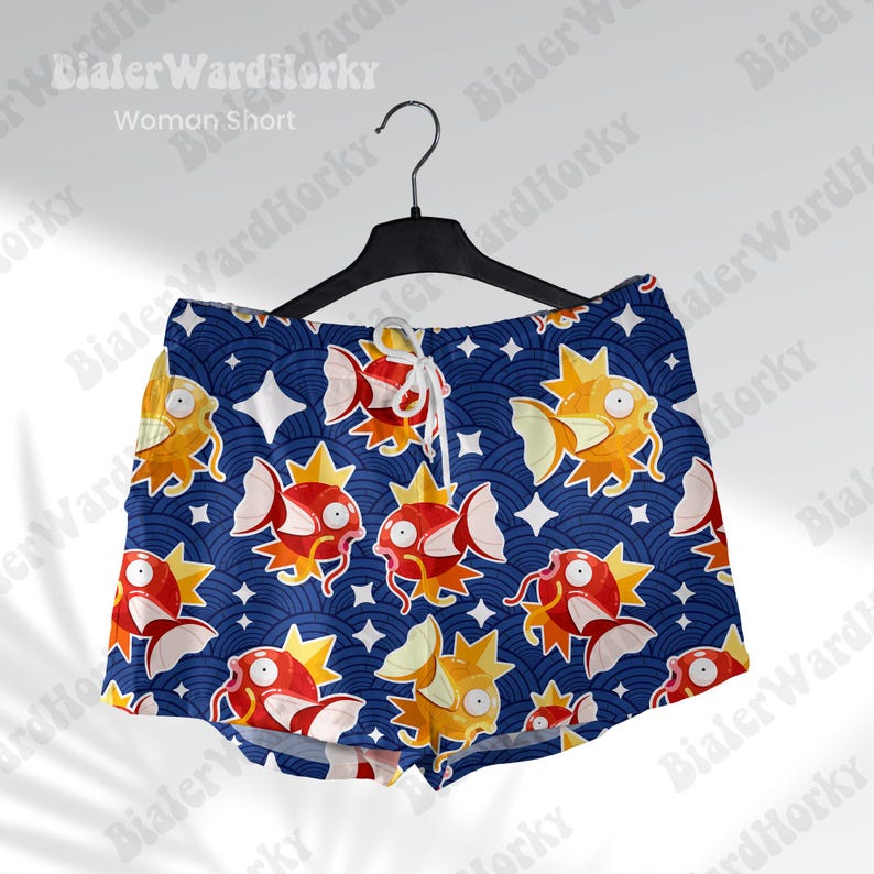 May include: Blue and white patterned shorts with a graphic print of a cartoon character. The character is a red, yellow, and white creature with a star on its head. The shorts have a drawstring waist.