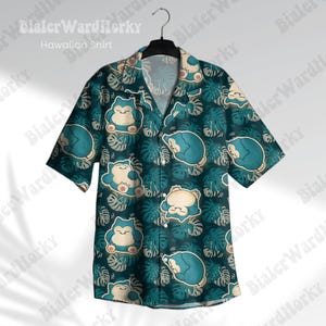 May include: A teal Hawaiian shirt featuring a repeating pattern of a cartoon character and tropical leaves. The shirt has short sleeves and a button-down front. The text "Hawaiian Shirt" is visible at the top.