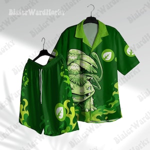 May include: A green short-sleeved button-down shirt and matching shorts set featuring a graphic of a creature with a large plant bulb on its back. The fabric displays a pattern of green flames and white leaf icons on a dark green background.