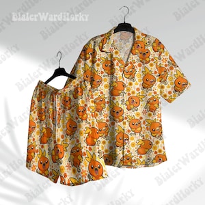 May include: A matching set of orange and yellow Hawaiian shirt and shorts. The shirt and shorts feature a repeating pattern of orange cartoon characters and yellow flowers on a white background. The shirt has short sleeves and a button-down front. The shorts have a drawstring waist.