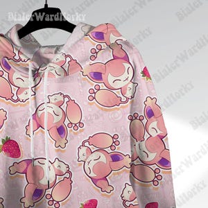 May include: Pink hoodie with a repeating pattern of a cartoon character, strawberries, and candy on a light pink background. The hoodie has a drawstring and a zipper. The image has the text "Bialer WardHorky" repeated.