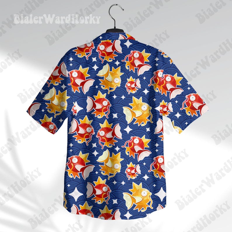May include: A blue short-sleeved button-up shirt with a repeating pattern of red and orange fish and stars.