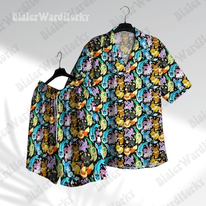 May include: A black and white patterned short-sleeved button-up shirt and matching shorts. The pattern features a variety of colourful cartoon characters.