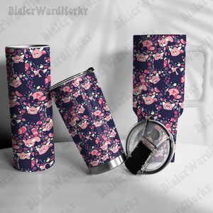 May include: Tumblers and a mug featuring a repeating pattern of red pandas, flowers, and leaves on a navy blue background. The tumblers are stainless steel with black lids. The mug has a white handle.