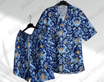 May include: A matching blue short-sleeved shirt and shorts set. The set features a repeating pattern of blue cartoon characters, flowers, and other shapes on a dark blue background. The shorts have a white drawstring.