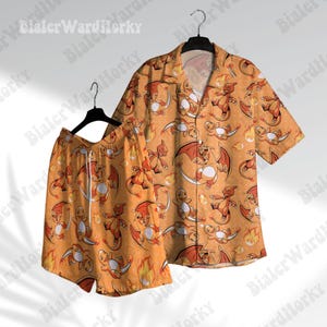 May include: Orange and white short-sleeved button-up shirt and matching shorts with a repeating pattern of cartoon fire-type Pokemon characters.
