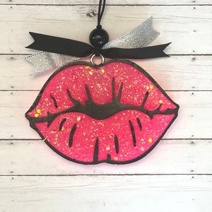 Large lips with glitter, bow and bead.