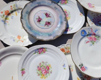 9 mix and match porcelain dessert plates and a floral pattern dish