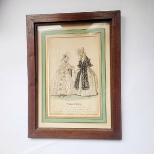 1837. Old and pretty poster under glass and wooden frame celebrating Parisian fashion