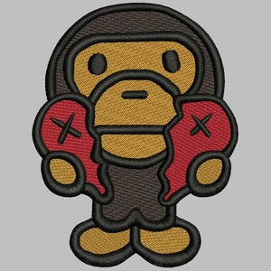 Könnte beinhalten: Ein brauner Comic-Affe mit gelbem Gesicht und schwarzen Augen hält zwei rote gebrochene Herzen mit einem X auf jedem. Der Affe trägt ein schwarzes Hemd und hat einen braunen Umriss.