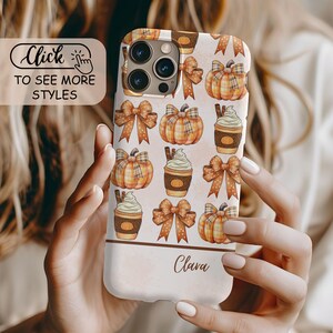 May include: A phone case featuring a repeating pattern of orange plaid pumpkins, brown bows with white dots, and coffee cups with whipped cream. The lower section is a solid light peach color with the name Clava written in a brown script font.