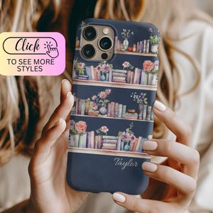 May include: A dark blue phone case featuring a repeating pattern of bookshelves filled with colorful books, potted plants, and floral arrangements. The name Taylor is printed in white script at the bottom of the case, which has a camera cutout.