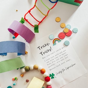 May include: A colorful craft project with a note that reads "Tricky, Tricky! But you can't catch me! I took your gold and got out with time to spare. Now, I've left you some goodies - it's only fair. Better luck next year, Lucky the Leprechaun."