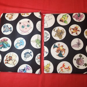 May include: Two black zippered pouches with a pattern of white circles containing various cartoon characters. The background is black, and the characters are in various colors. The pouches are rectangular.