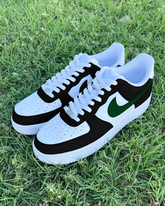 black nike with green swoosh
