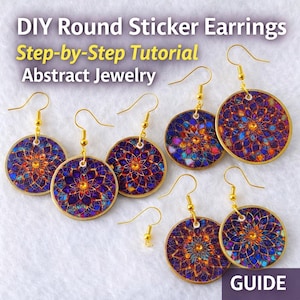 May include: Round sticker earrings with a colorful floral design. The earrings have gold-colored hooks and a circular shape. The image includes text that reads "DIY Round Sticker Earrings Step-by-Step Tutorial Abstract Jewelry GUIDE."