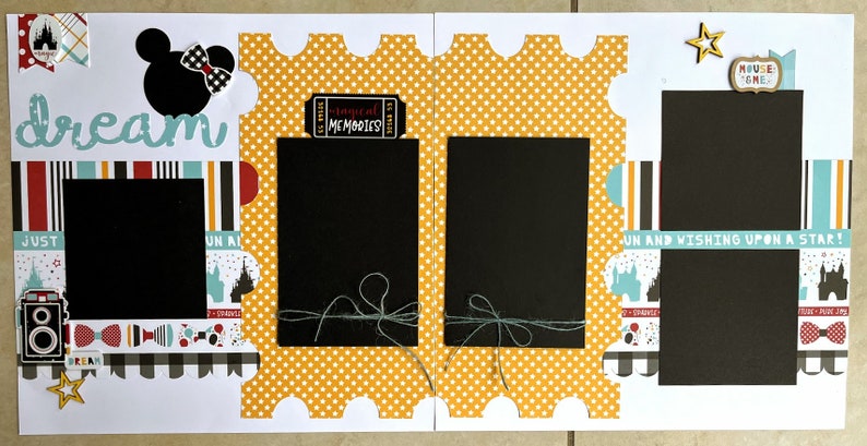 May include: A scrapbook layout with a Disney theme. It features a black Mickey Mouse silhouette with a bow, the word "dream", and several photo spaces. Decorative elements include a camera, ticket, and star accents.