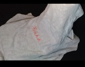 May include: A white hooded towel with the name "Rebekah" embroidered in pink on the front.