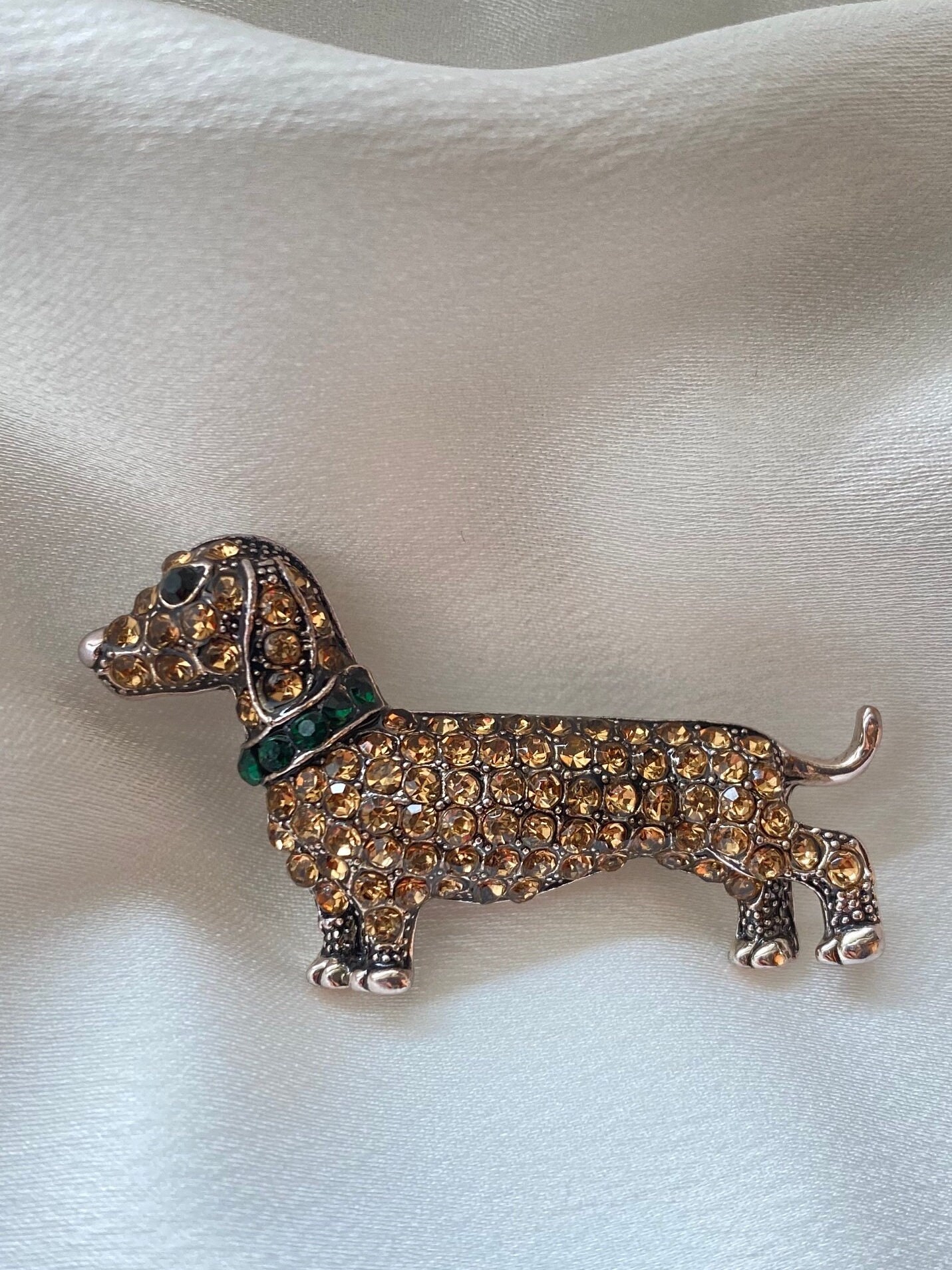 Dachshund dog pin, pewter look, pink eyes, very nice finish.