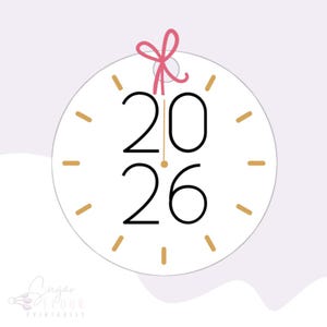 May include: A white circle with a gold clock face and black numbers that read "2026". A pink bow is at the top of the circle.