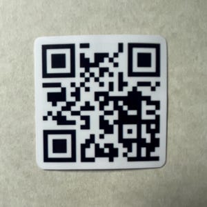 May include: Black and white QR code on a white background.