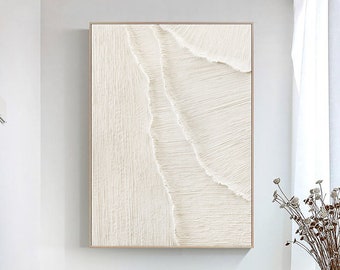 May include: Abstract white wall art with a textured, layered design. The artwork is framed in a thin, gold frame.