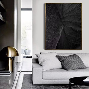 Puede incluir: Una impresi&oacute;n de arte abstracto en blanco y negro con un marco dorado. La impresi&oacute;n presenta un dise&ntilde;o texturizado y arremolinado.