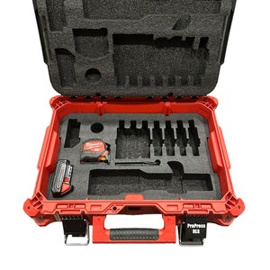 May include: Red tool case with black foam inserts. The case is open and contains a variety of tools, including a tape measure, a battery, and a drill bit set. The case has a black handle and a label that reads "ProPress RLS".