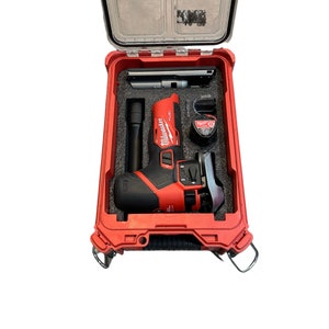 May include: A red Milwaukee FUEL jigsaw with a black handle and a clear plastic case. The case has a foam insert to hold the jigsaw and its accessories.