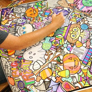 May include: A large colouring page featuring a variety of Halloween-themed illustrations. The page is filled with colourful images of pumpkins, ghosts, bats, candy corn, and other spooky characters. The page is partially coloured in with bright colours, including orange, yellow, green, and purple.