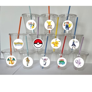 May include: Set of 12 clear plastic cups with colorful straws and round Pokemon character stickers. The stickers feature various Pokemon characters, including Pikachu, Charizard, and Bulbasaur.