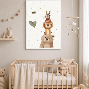 May include: A framed nursery art print featuring a stack of illustrated animals: a bear, lion, rabbit, and a bee. The artwork has a soft color palette with a heart and colorful dots. The print is displayed in a baby's nursery with a crib and mobile.
