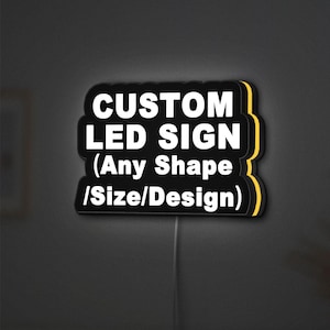 May include: A custom LED sign with the text "CUSTOM LED SIGN (Any Shape /Size/Design)" in white on a black background. The sign has a yellow outline and is illuminated. A power cord extends from the bottom.