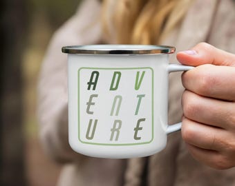 May include: White enamel mug with a green and white design that says "ADVENTURE" in a blocky font.