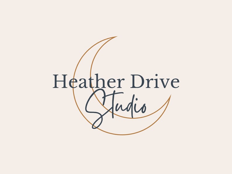 May include: A logo design featuring the text "Heather Drive Studio" in a dark blue serif font, with "Studio" in a cursive script. A gold crescent moon shape frames the text on a cream background.
