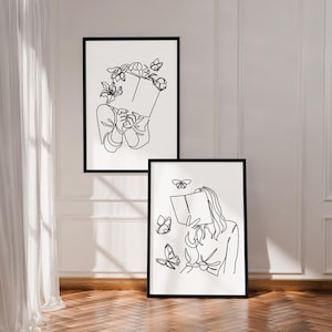 May include: Two framed wall art prints featuring black line art on a white background. The top print shows a figure holding a book with flowers around their head. The bottom print depicts a figure holding a book surrounded by flying butterflies.