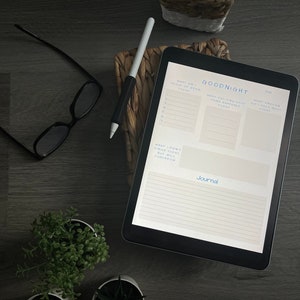 May include: A digital tablet displaying a printable journal page with the title "Goodnight" and sections for "What am I proud of from today", "What exciting/good thing happened today", "What emotion did I feel most today", and "What didn't I finish today but will tomorrow".