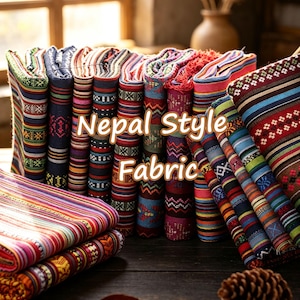 May include: A collection of folded fabric pieces featuring vibrant, multi-colored horizontal stripes and intricate geometric patterns. The textiles display a variety of hues including red, blue, green, and yellow, with the text Nepal Style Fabric.
