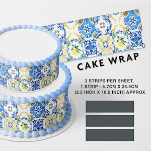 May include: A two-tiered cake decorated with blue and yellow patterned edible cake wrap. The cake wrap features a tile design with lemons and flowers. The text on the image reads "CAKE WRAP 3 STRIPS PER SHEET, 1 STRIP - 5.7CM X 26.5CM (2.5 INCH X 10.5 INCH) APPROX".