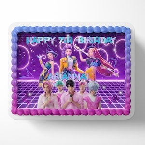 May include: A rectangular cake with purple and blue frosting. The cake features a vibrant graphic of anime-style characters against a purple background with the text "HAPPY 7TH BIRTHDAY ARIANNA!". The cake has a decorative border.