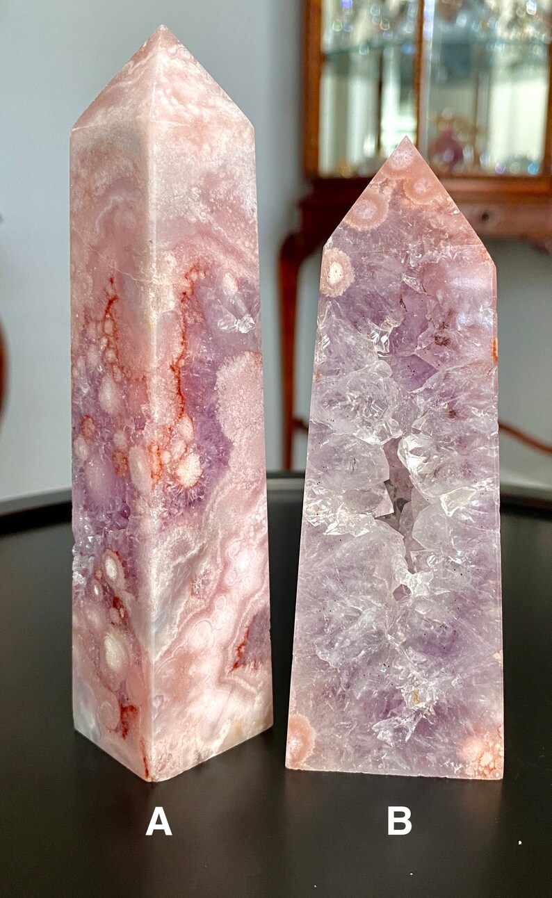 May include: Two amethyst crystal points, one with a pink and purple color and the other with a light purple color. The crystals are labeled A and B.