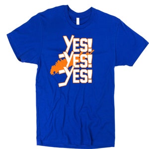 May include: A royal blue t-shirt with an orange outline of the state of New York and the text "YES! YES! YES!" in white.