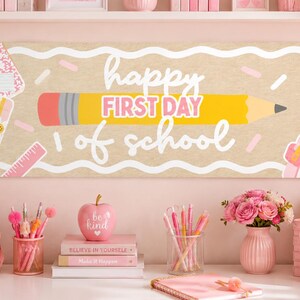 May include: A rectangular banner featuring a tan background with white wavy lines, a large yellow pencil, and the text "happy FIRST DAY of school" in white and pink. The design includes illustrations of pink notebooks, a pencil with a bow, and a ruler.