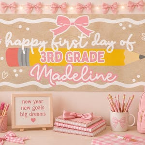 May include: A horizontal banner with a kraft paper background featuring a yellow pencil graphic, pink bows, and the text happy first day of 3RD GRADE Madeline. The scene includes pink notebooks, a backpack, a mug with pencils, and a framed sign.